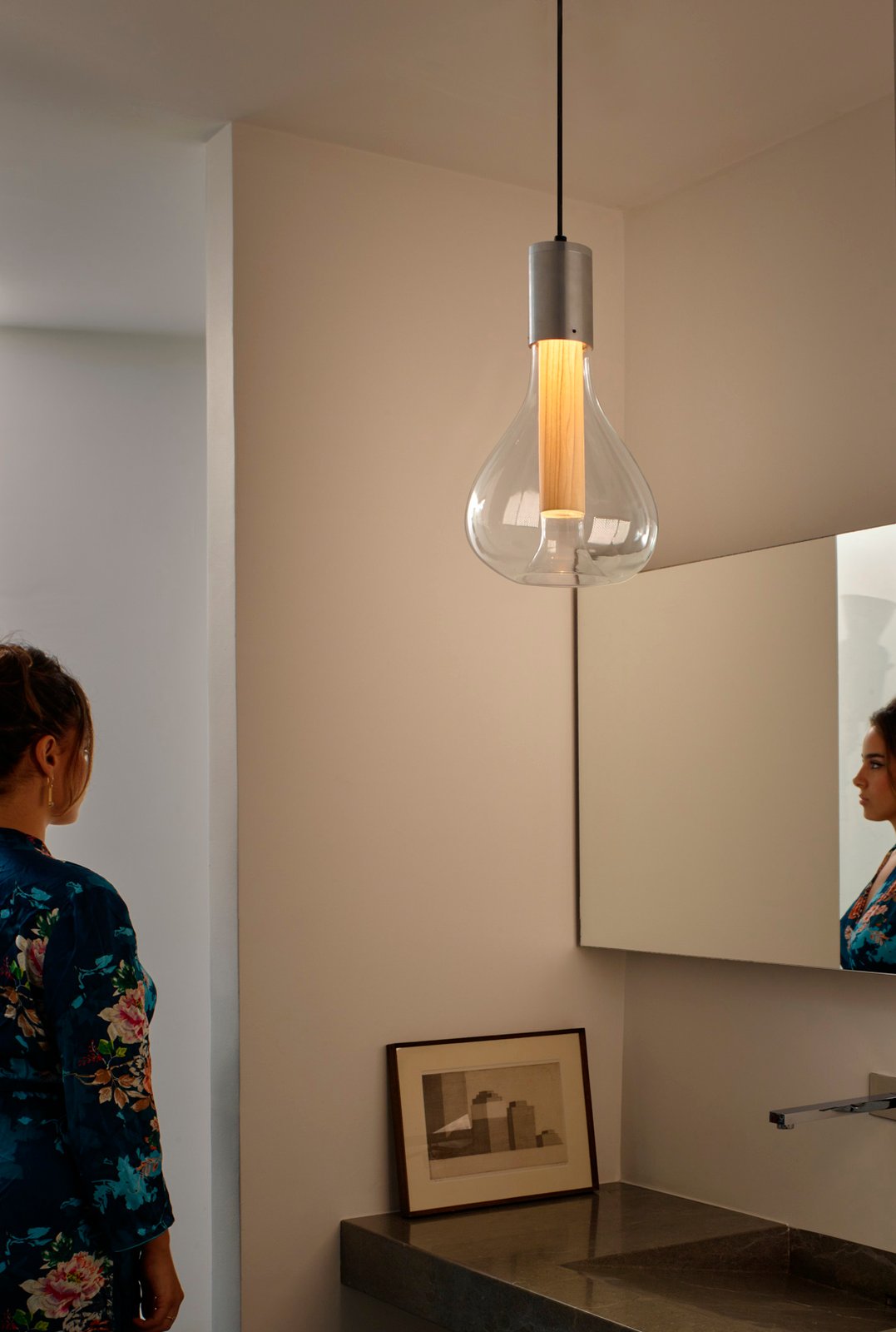 bathroom illuminated-with-the-Eris-lamp-by-lzf-lamps-that-provides-a-soft-and-pleasant-atmosphere-with-its-glass-paired-with-wood