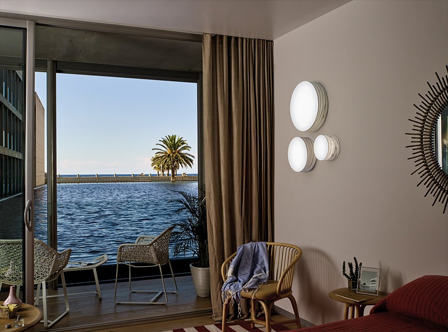 Detail of-circular-sconces-of-different-sizes-in-gray-on-the-wall-of-a-hotel-room