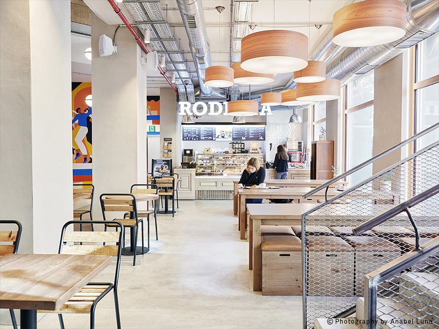 Interior of-a-cafeteria-with-LZF's-Gea-circular-lamps-in-natural-cherry-wood