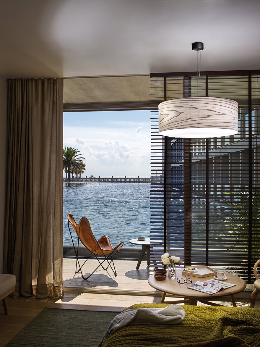 Interior of-a-hotel-room-illuminated-with-the-LZF-Gea-wooden-lamp-in-gray-color