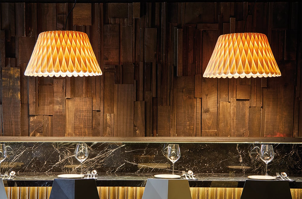 Restaurant bar-area-illuminated-with-geometric-pattern-lamps-in-LZF-natural-beech-veneer