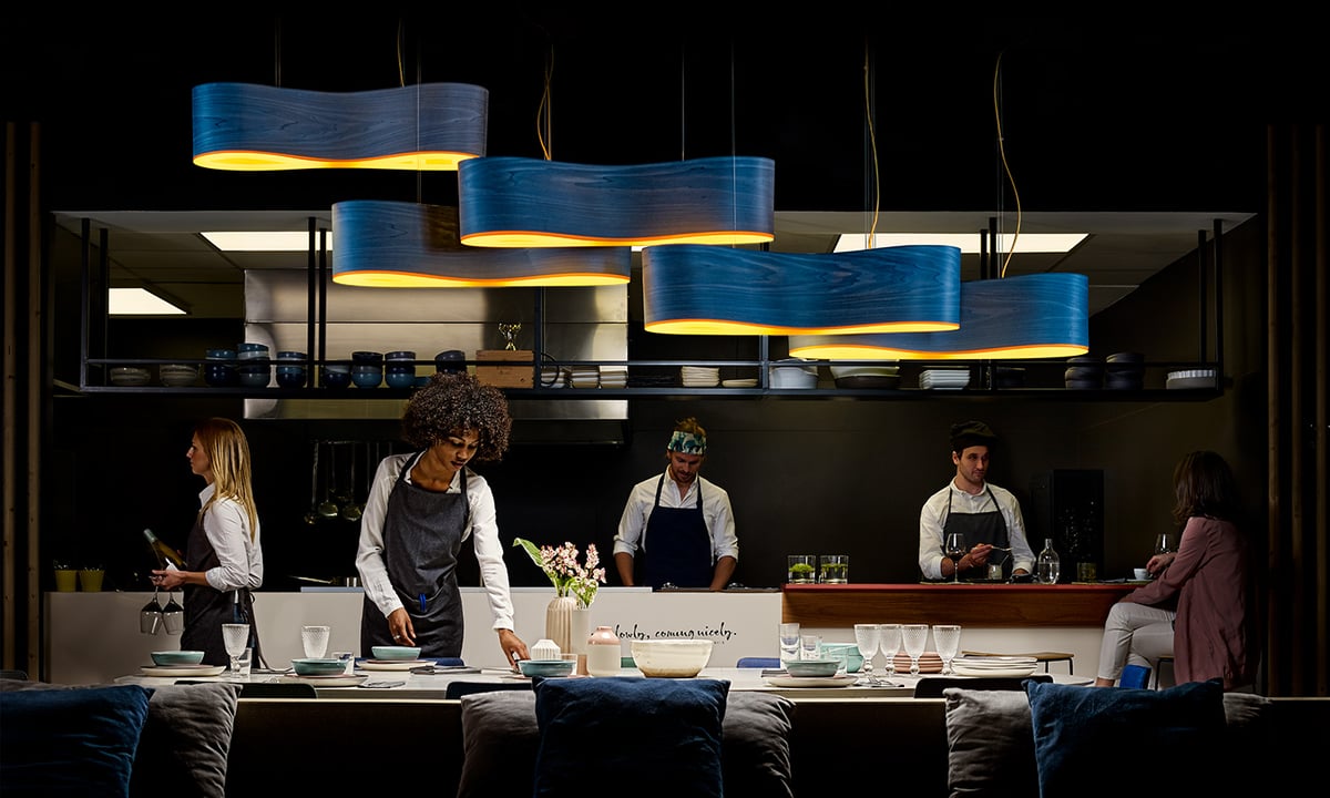 Restaurant illuminated-with-a-composition-of-wood-veneer-lamps-in-blue-color